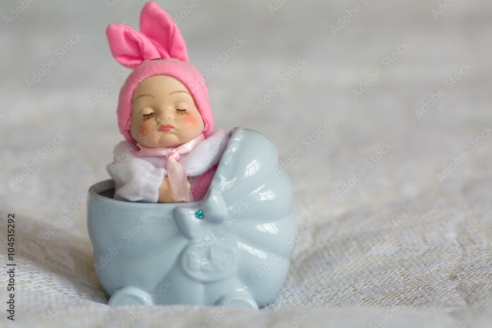decorative porcelain figurine of a child in a stroller decorative porcelain figurine of a child in a stroller