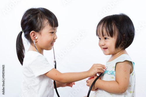Asian Little Chinese Girls Playing as Doctor and Patient with St
