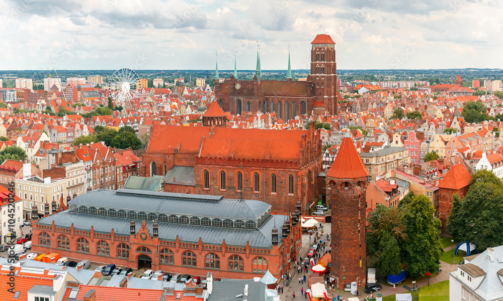 Fototapeta premium Aerial view of the Saint Mary Church, Market Hall and Tower Jacek in the cloudy summer morning, Gdansk, Poland