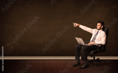 Businessman holding high tech laptop on background with copyspac