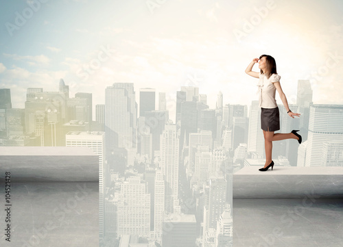 Businesswoman standing on the edge of rooftop