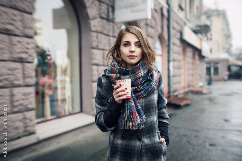young adult female with paper cup of coffee staying on the city young adult female with paper cup of coffee staying on the city