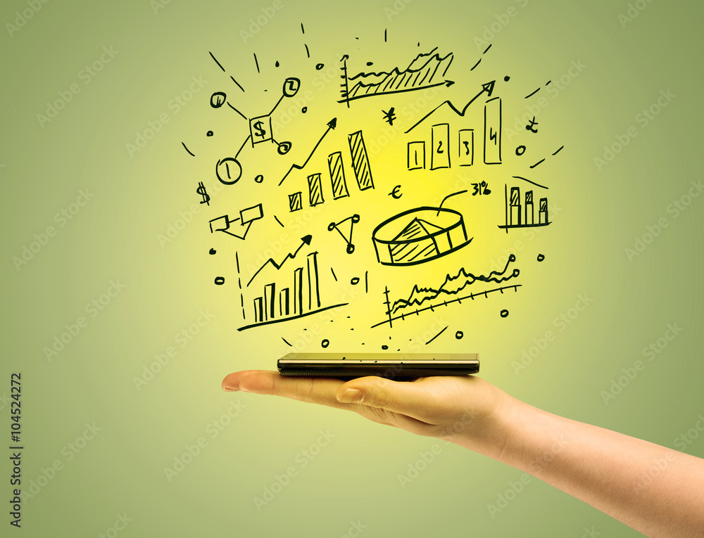 Obraz premium Sales charts on top of mobile phone in hand