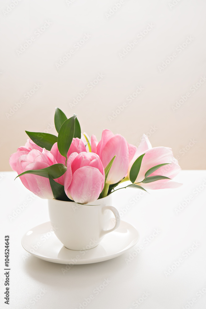  fresh spring pink tulips in cup on white background