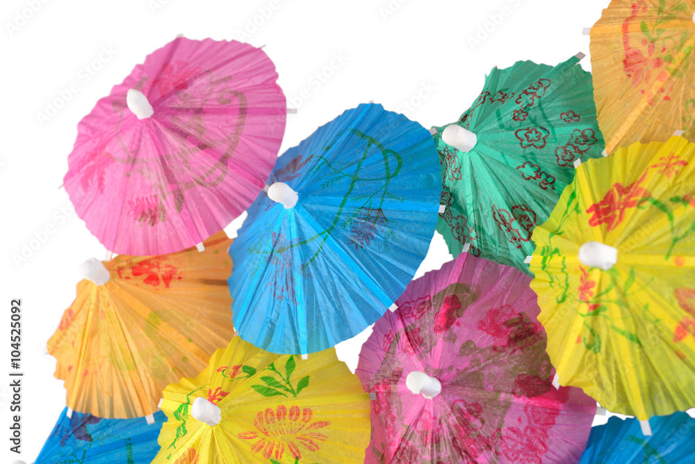 Colorful paper cocktail umbrella close-up on a white