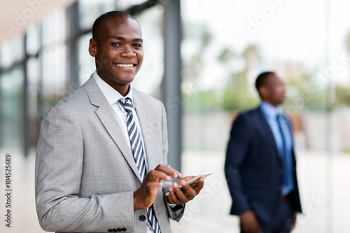 young african businessman reading email on smart phone
