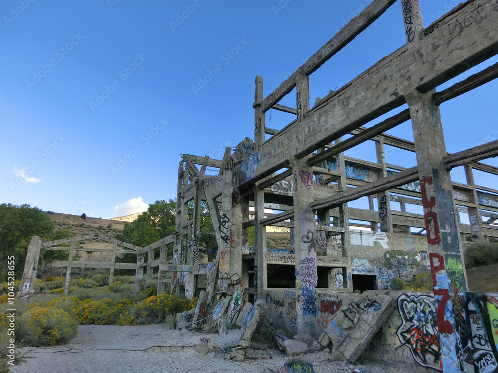Abandoned cyanide factory exterior with skeletal cement walls remaining - landscape color photo Abandoned cyanide factory exterior with skeletal cement walls remaining - landscape color photo