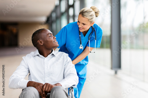female nurse talking to disabled patient photo