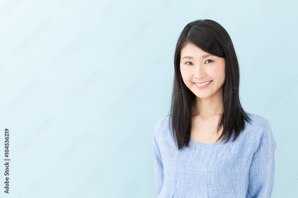 attractive asian woman on blue background attractive asian woman on blue background