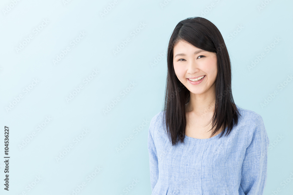 attractive asian woman on blue background attractive asian woman on blue background
