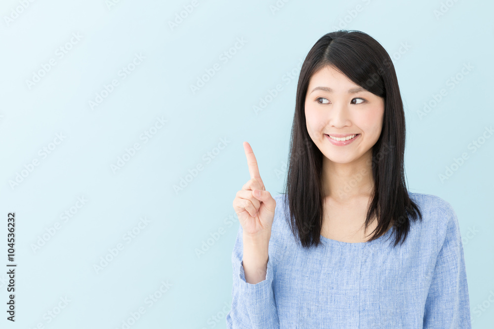 attractive asian woman on blue background attractive asian woman on blue background