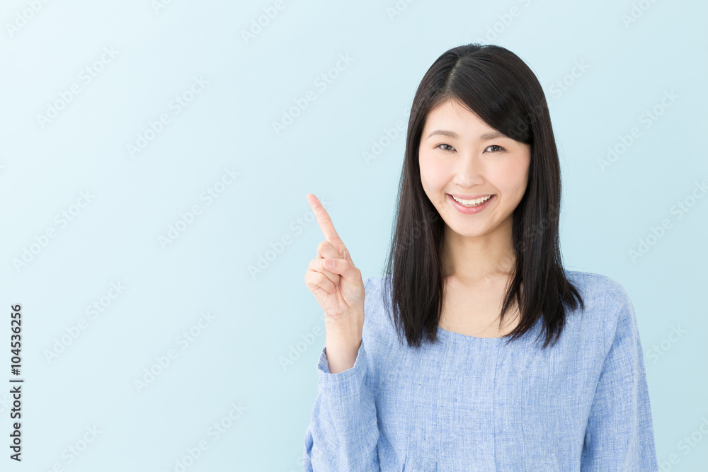 attractive asian woman on blue background attractive asian woman on blue background