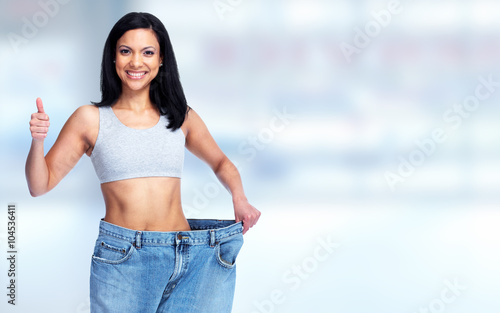 Fotografie Slimming woman wearing big pants.