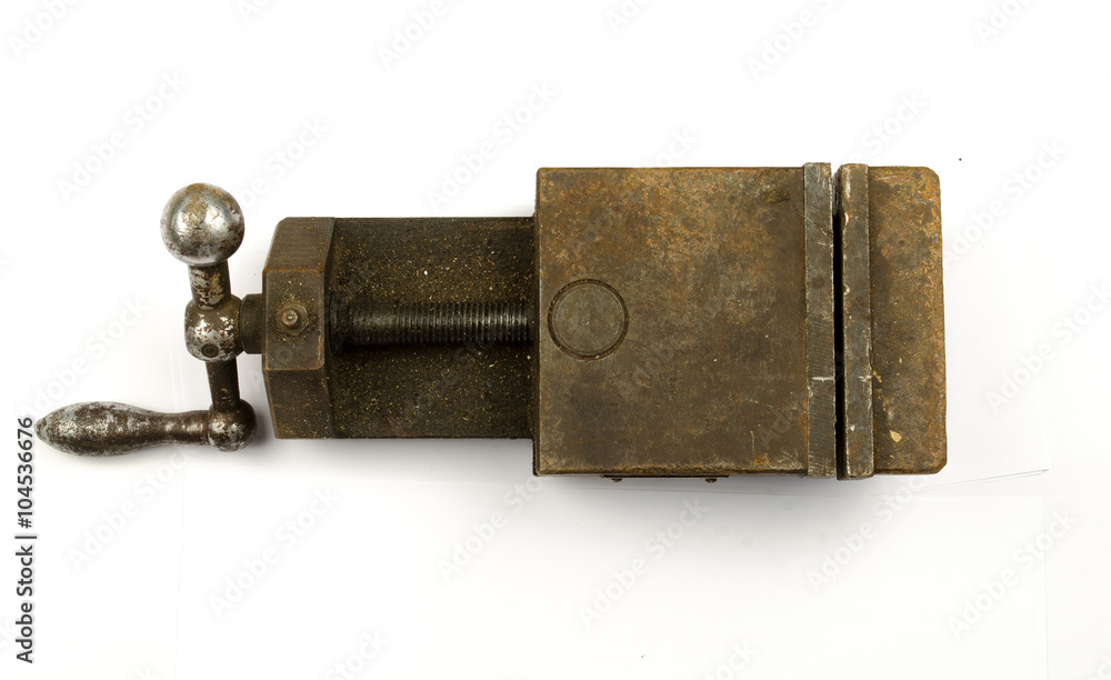 Color shot with a red vice isolated on white. Blacksmiths vice closeup. Old rusty all-steel vice-grip. Weathered vintage clamping device Color shot with a red vice isolated on white. Blacksmiths vice closeup. Old rusty all-steel vice-grip. Weathered vintage clamping device