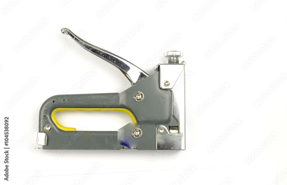 stapler on a white background. Concept of home improvement. Single gray metal stapler. Isolated on white background. Close-up. Studio photography. stapler on a white background. Concept of home improvement. Single gray metal stapler. Isolated on white background. Close-up. Studio photography.