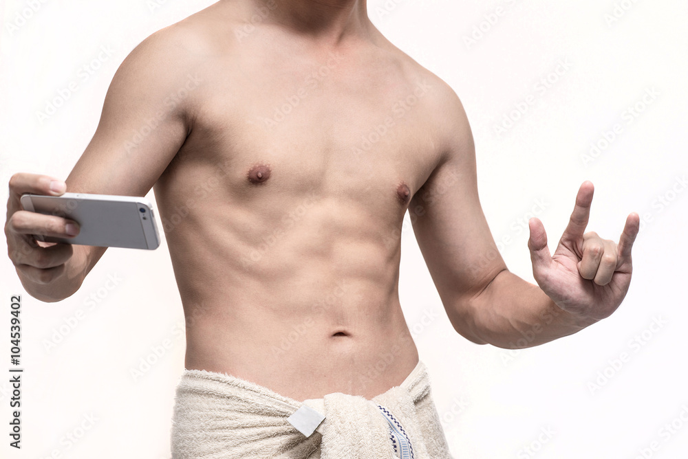 Fototapeta premium Man taking a selfie with his phone and show his hand in I love you