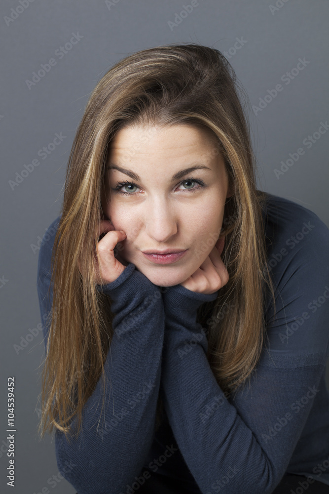 reflection concept - portrait of a beautiful young girl pouting in thinking about her shyness with reserved body language, gray background studio reflection concept - portrait of a beautiful young girl pouting in thinking about her shyness with reserved body language, gray background studio