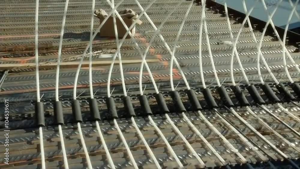 Heating is distributed under a building through radiant piping during construction.