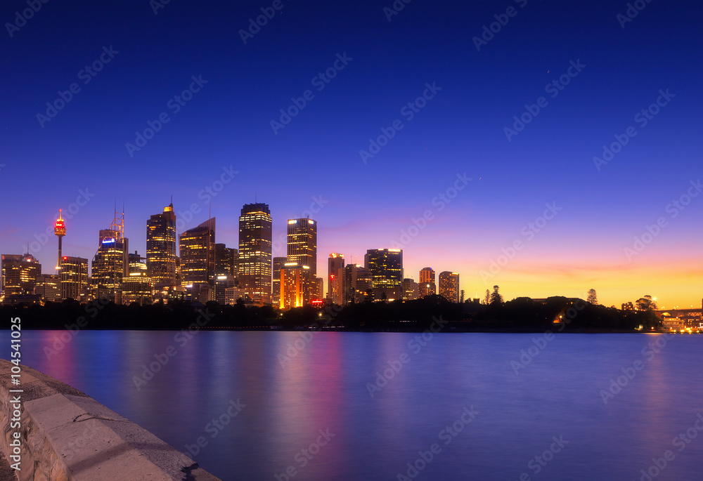 Fototapeta premium Australia Sydney city CBD view from cremorne point over harbour waters at sunset, taken by long exposure technique