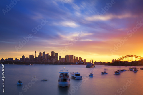 Australia Sydney city CBD view from cremorne point over harbour waters at sunset, taken by long exposure technique