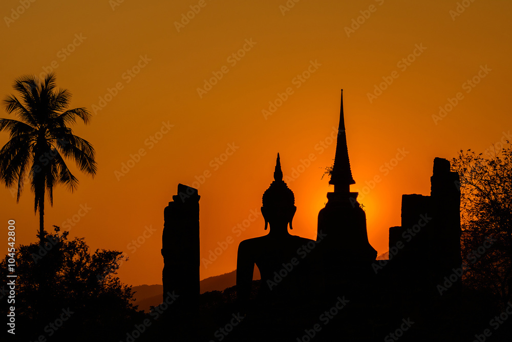 Silhouetteat of Buddha and pagada on sunset time at  Sukhothai H