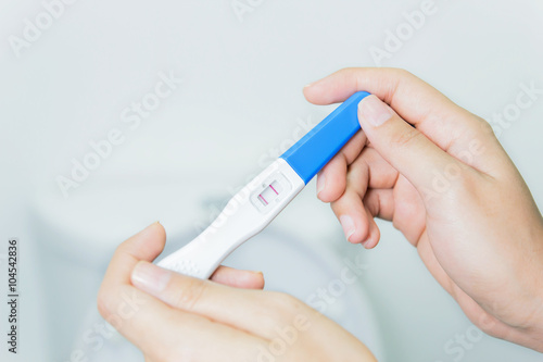Woman checking pregnancy test