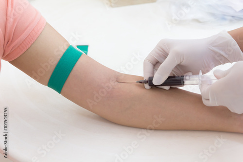 Laboratory with nurse taking blood sample from patient