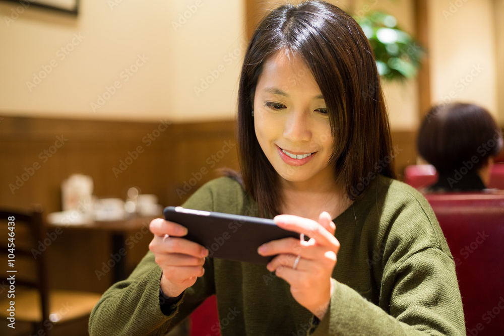 Woman play game on mobile phone Woman play game on mobile phone