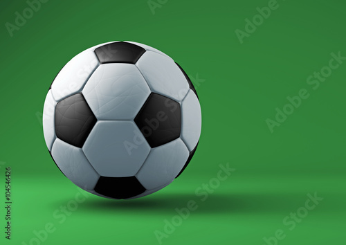 Soccer ball with shadows on green background.