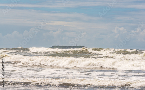scene of island and light pole with strong wave in the windy day