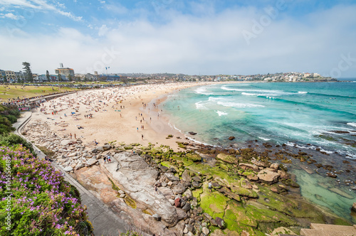 Bondi Beach, Sydney, Australia - OCT 25, 2014: Tourists and swimmers relaxing on the beach in summer at Bondi Beach