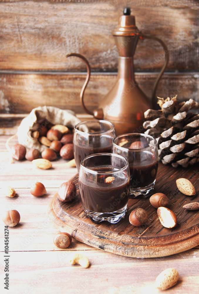Hot chocolate in a glass cup with nuts and cinnamon Hot chocolate in a glass cup with nuts and cinnamon