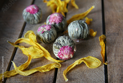 Flowering tea balls on a wooden tray 2 photo