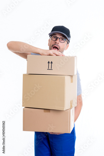 overstrained postman with parcels photo