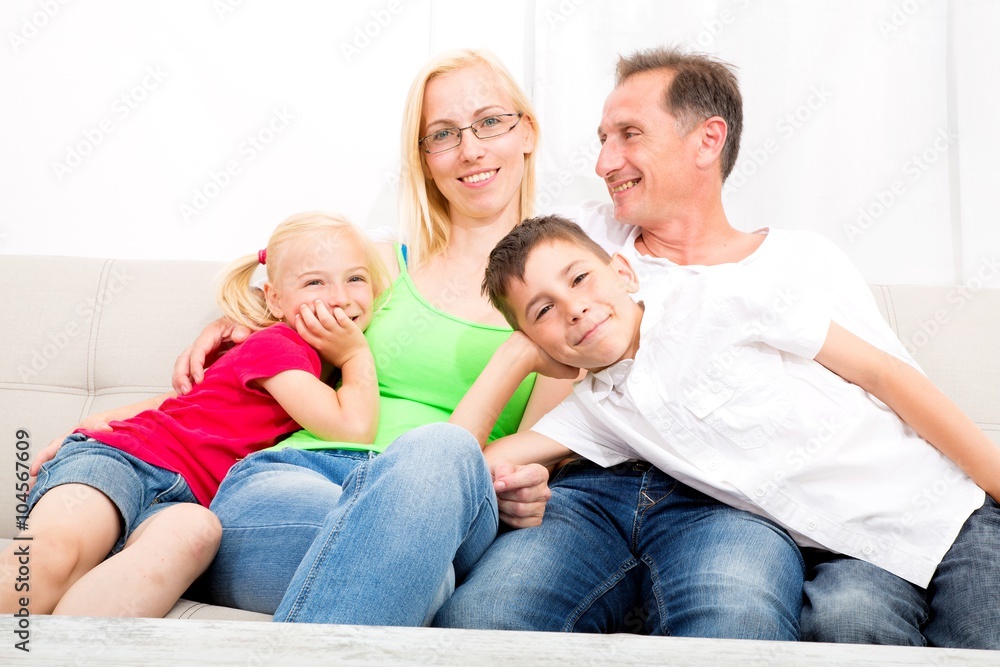 Happy family sitting together on the couch.