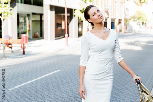 Business woman pulling suitcase bag walking in city