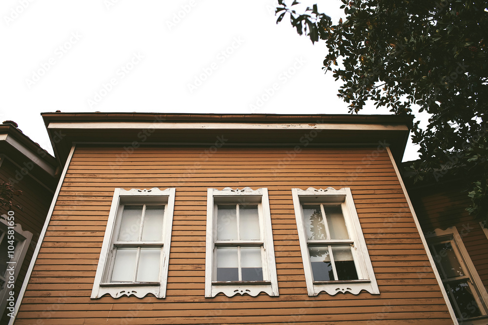 Fototapeta premium wooden house facade with windows