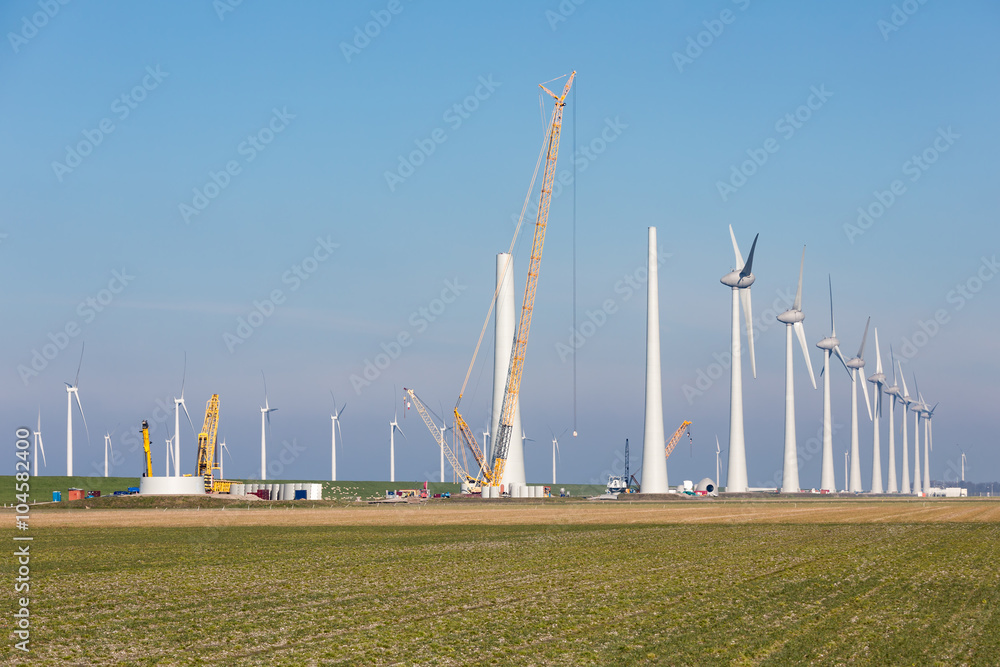 Construction site of new big Dutch wind farm in agricultural landscape Construction site of new big Dutch wind farm in agricultural landscape