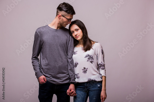Romantic love hipster couple posing at camera. Caucasian couple against white background.