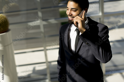 Young black man with teleph...