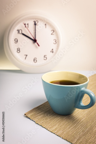 Black coffee with clock background, vintage tone