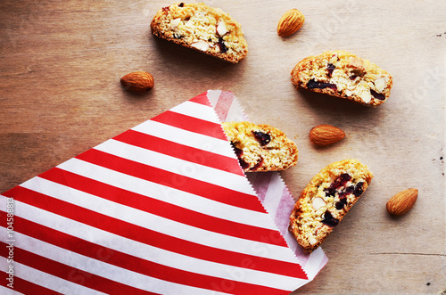 Biscotti with almond and dried cranberries in paper bag photo