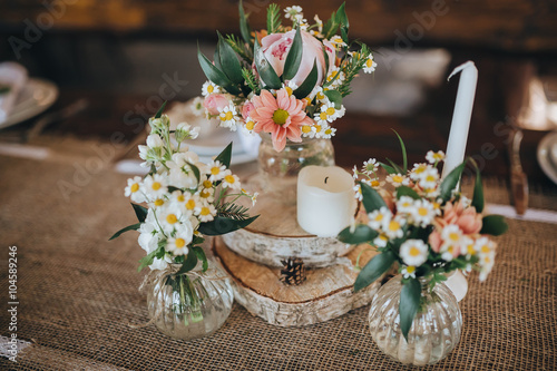 decorations made of wood and wildflowers served on the festive table