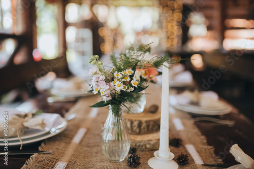 decorations made of wood and wildflowers served on the festive table