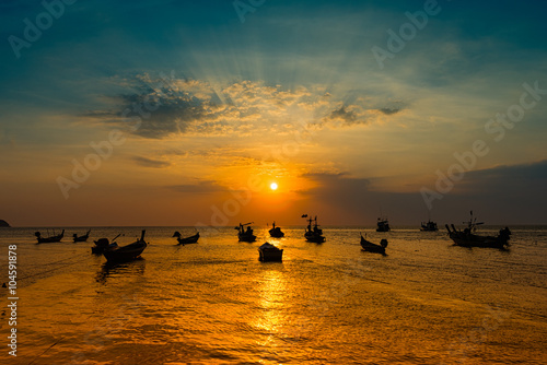 Fleet of fishing ship and sunset in evening photo