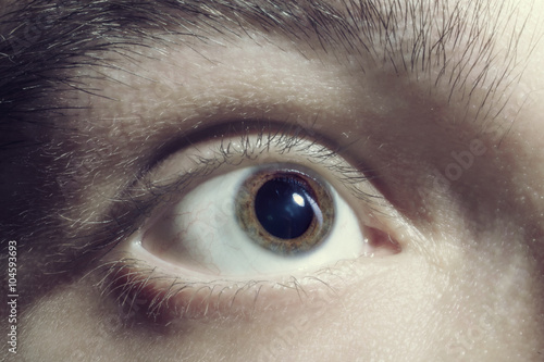 Male eye with dilated pupil photo