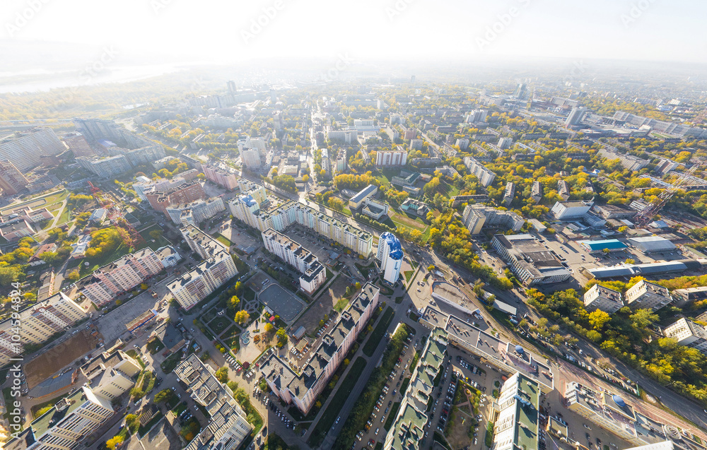 Obraz premium Aerial city view with crossroads, roads, houses, buildings and parks .