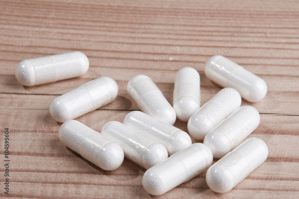white pills on wood white pills on wood