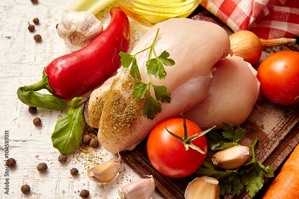 Raw chicken breast and vegetables Raw chicken breast and vegetables