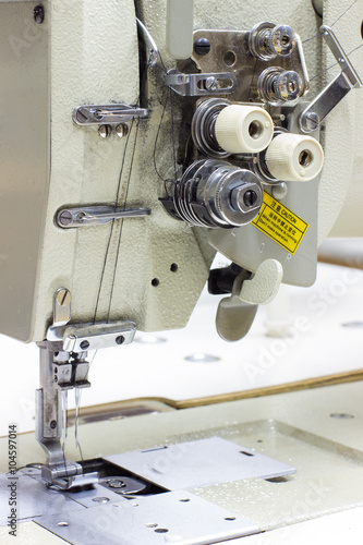 Five Thread Industrial Serger / Overlock Sewing Machine. An overlock is a kind of stitch that sews over the edge of one or two pieces of cloth for edging, hemming, or seaming photo